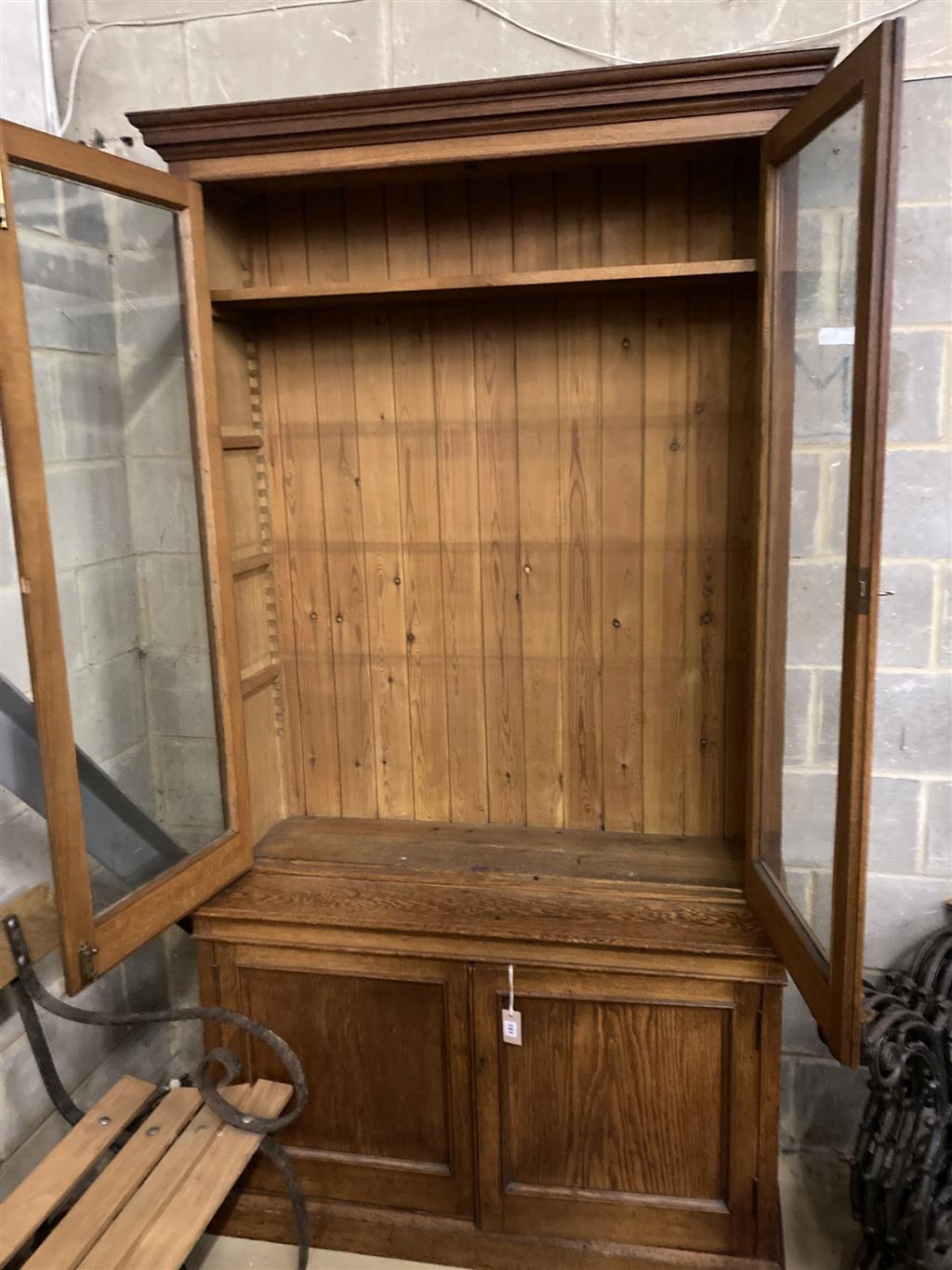 A late 19th century panelled oak library bookcase, length 118cm, depth 47cm, height 223cm